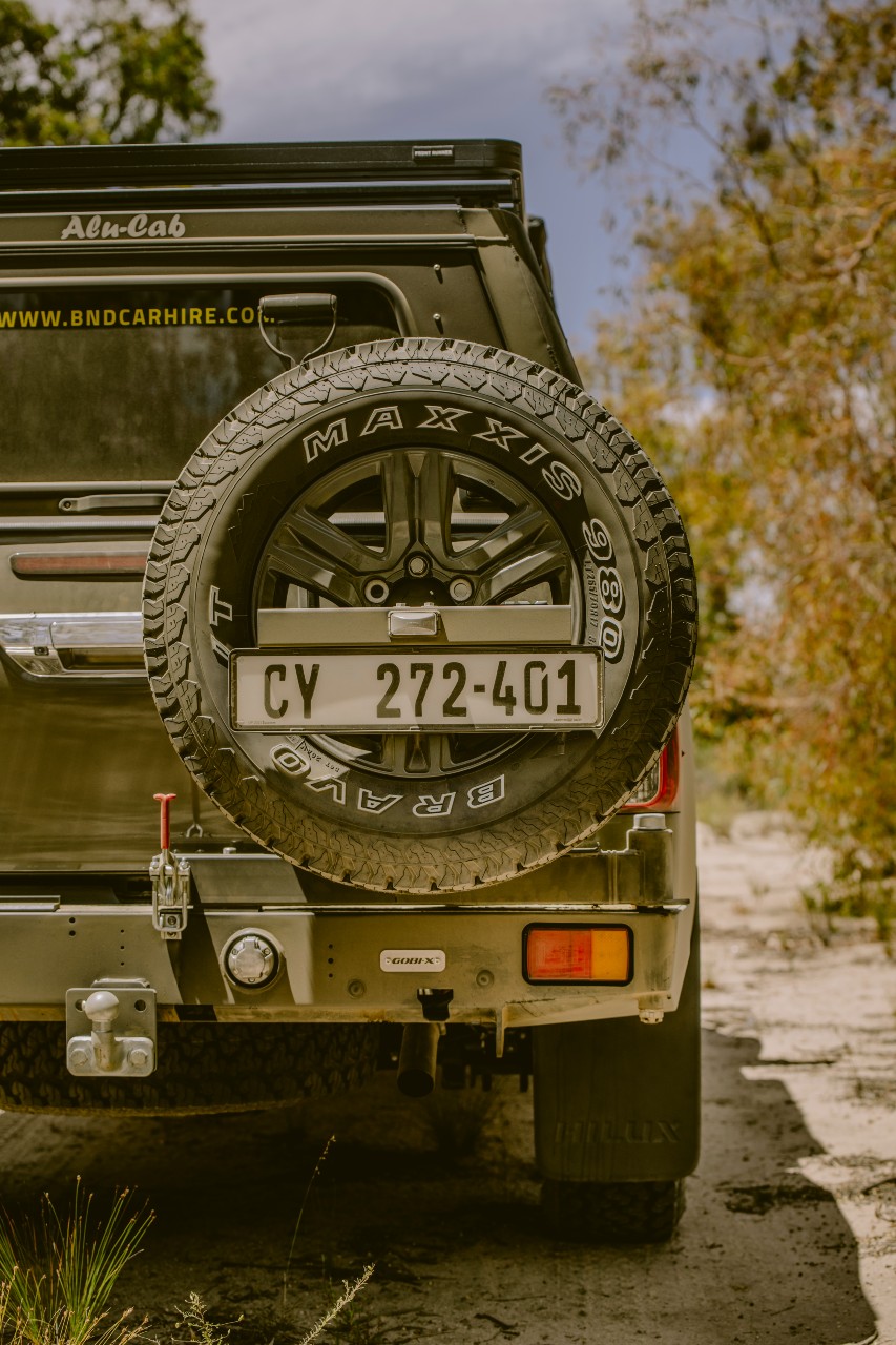 Rear view of a BND Car Hire vehicle showing a rugged MAXXIS spare tire, essential for the adventurous terrains of africa.