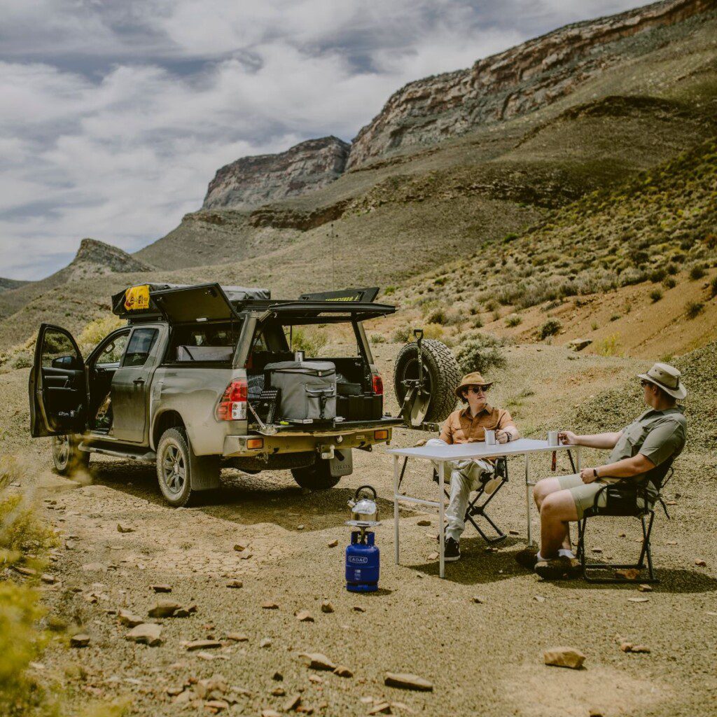 Travellers enjoying a road trip picnic with their 4x4 car hire from Bush and Desert Car Hire.