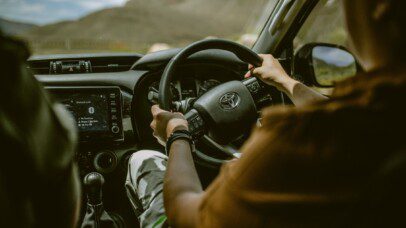 Off-road driving with a Bush and Desert Car Hire vehicle on a scenic route through Namibia's rolling hills, showcasing the comfort and control of the vehicle.