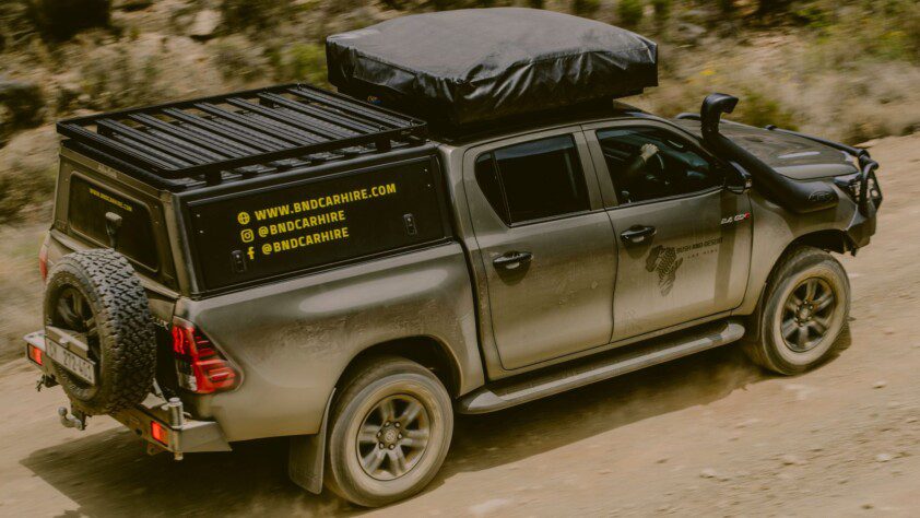 4x4 safari vehicle car hire equipped with rooftop tent and custom canopy, ready for adventure in Africa.