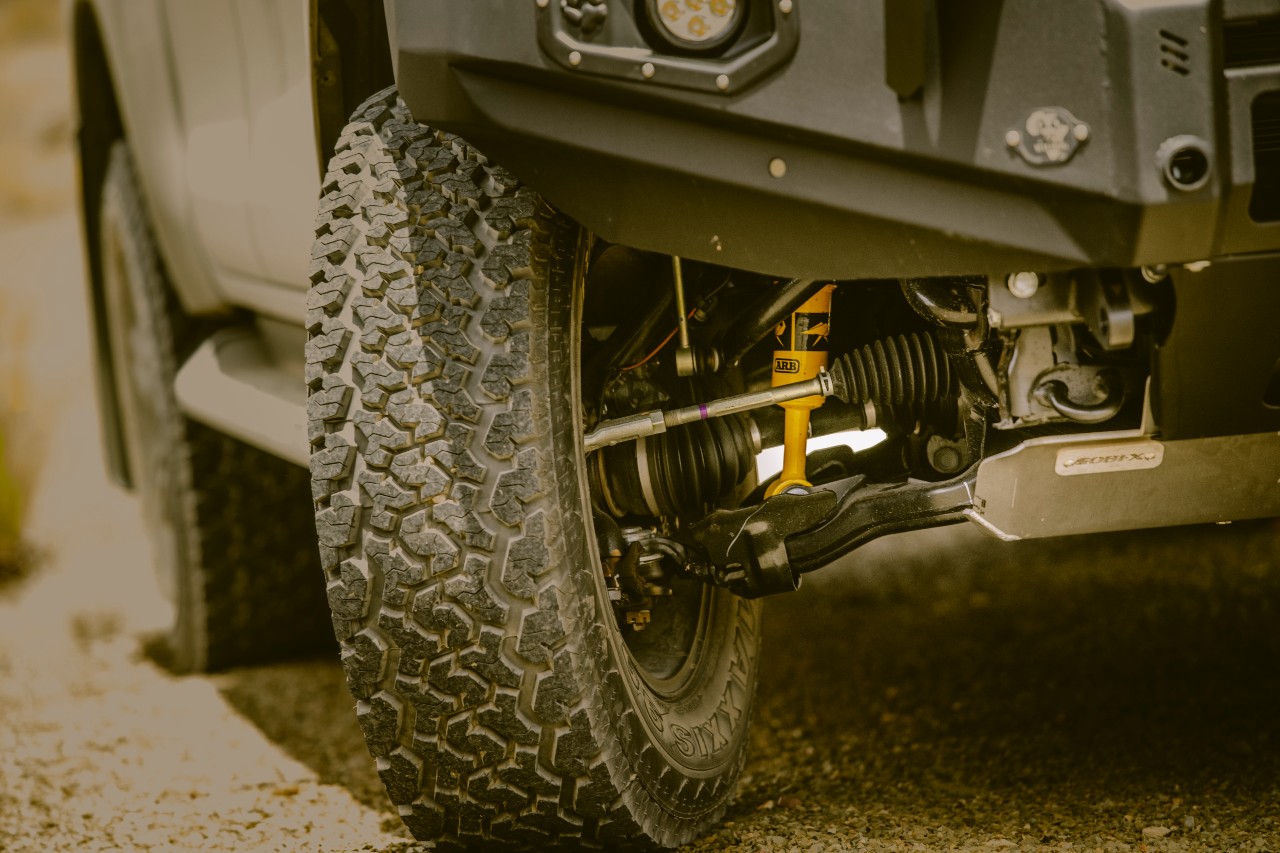 Close-up of a durable off-road tire on a BND Car Hire 4x4, highlighting the vehicle's readiness for Namibia's challenging terrains.