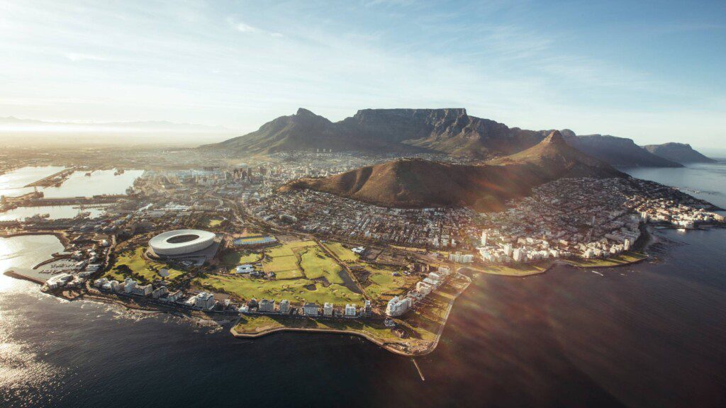 Aerial view of Table Mountain and Cape Town cityscape with surrounding natural beauty
