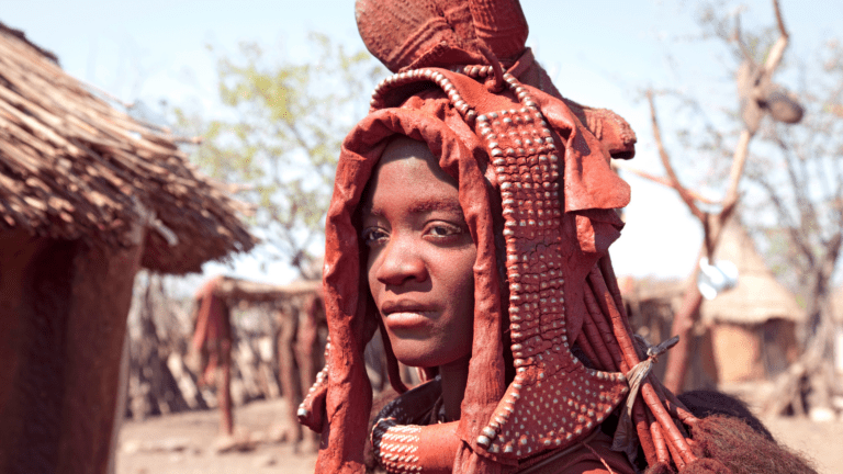 Himba woman in traditional attire in Namibia, highlighting the cultural richness explored with a 4x4 rental Windhoek.