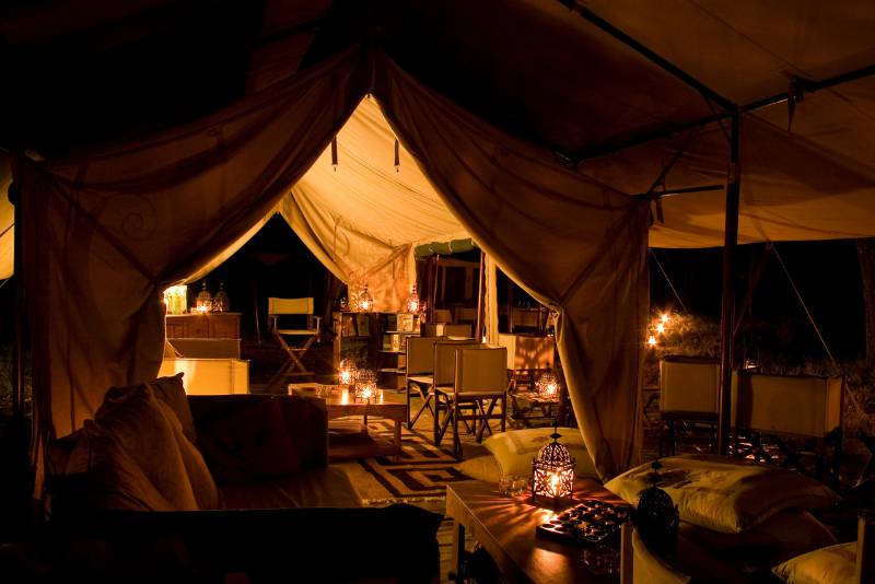 Luxury safari camp tent illuminated at night