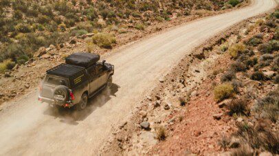 Hilux Double Cab driving on a rugged dirt road in Southern Africa