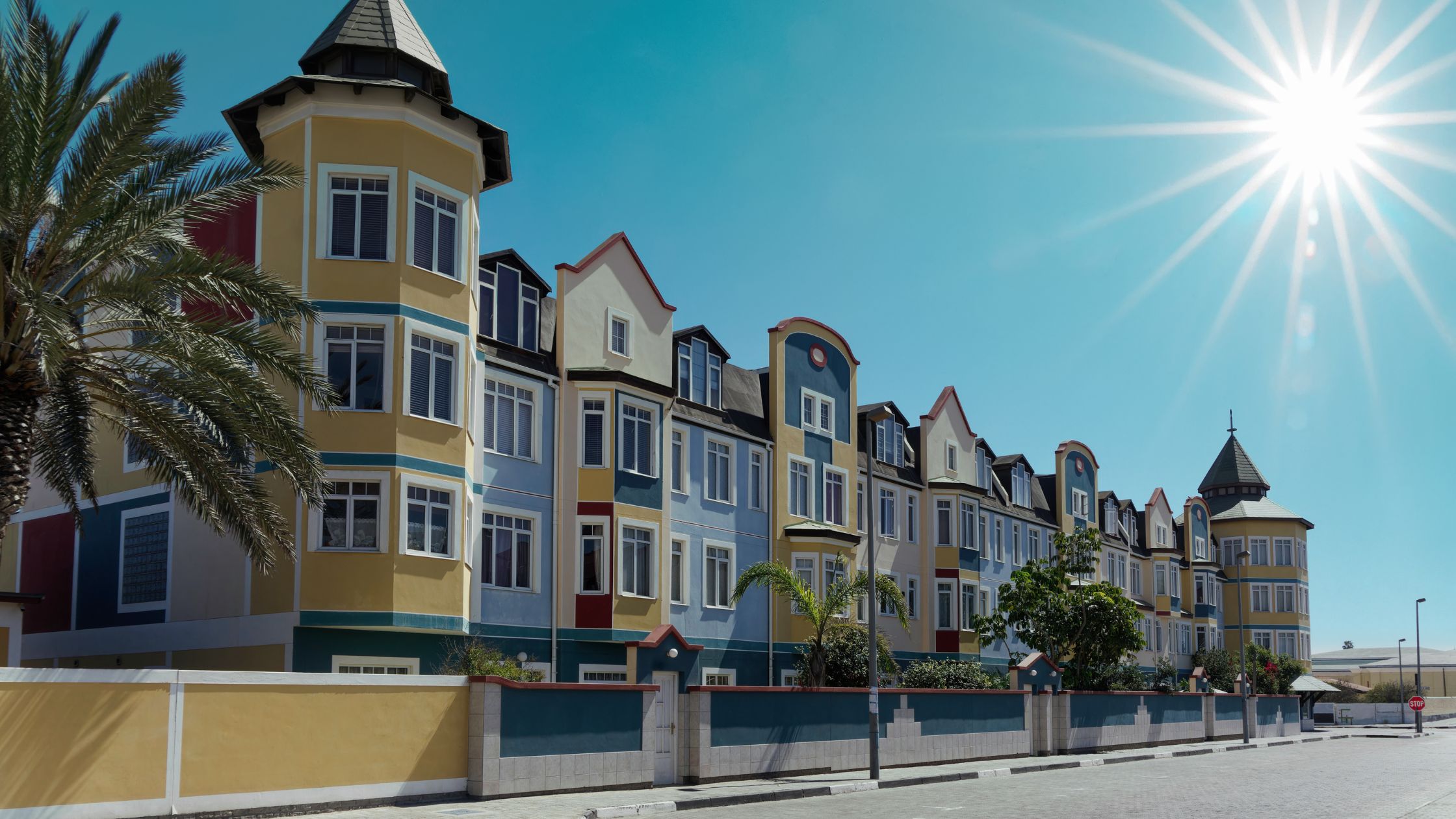 German colonial architecture in Swakopmund, Namibia, showcasing colorful buildings and bright blue skies while overlanding Namibia