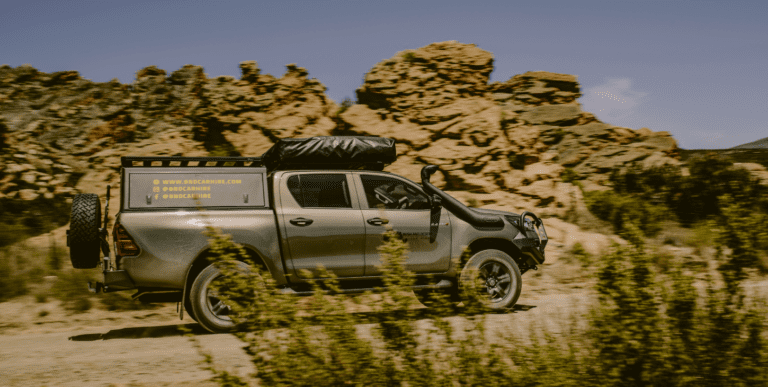 4x4 vehicle on a rugged trail during a summer road trip adventure.