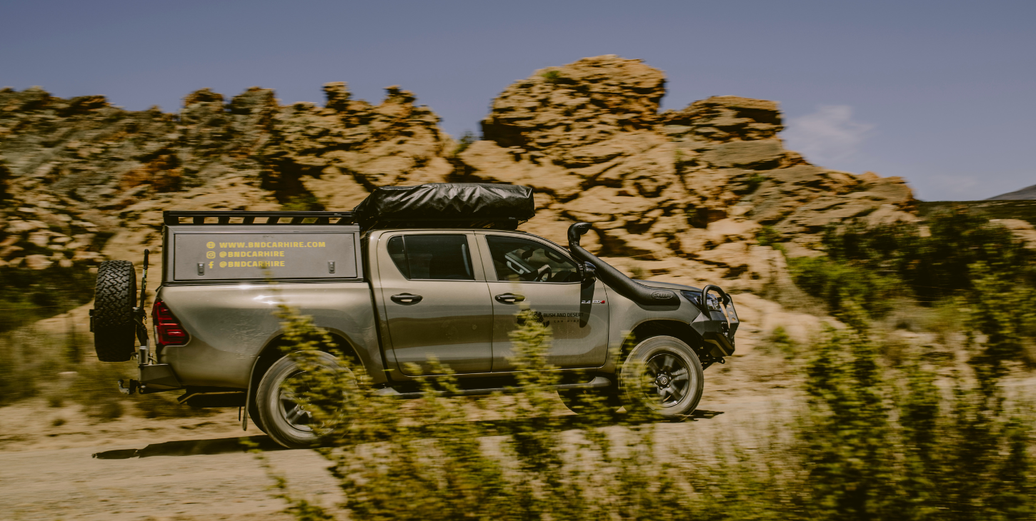 4x4 vehicle on a rugged trail during a summer road trip adventure.